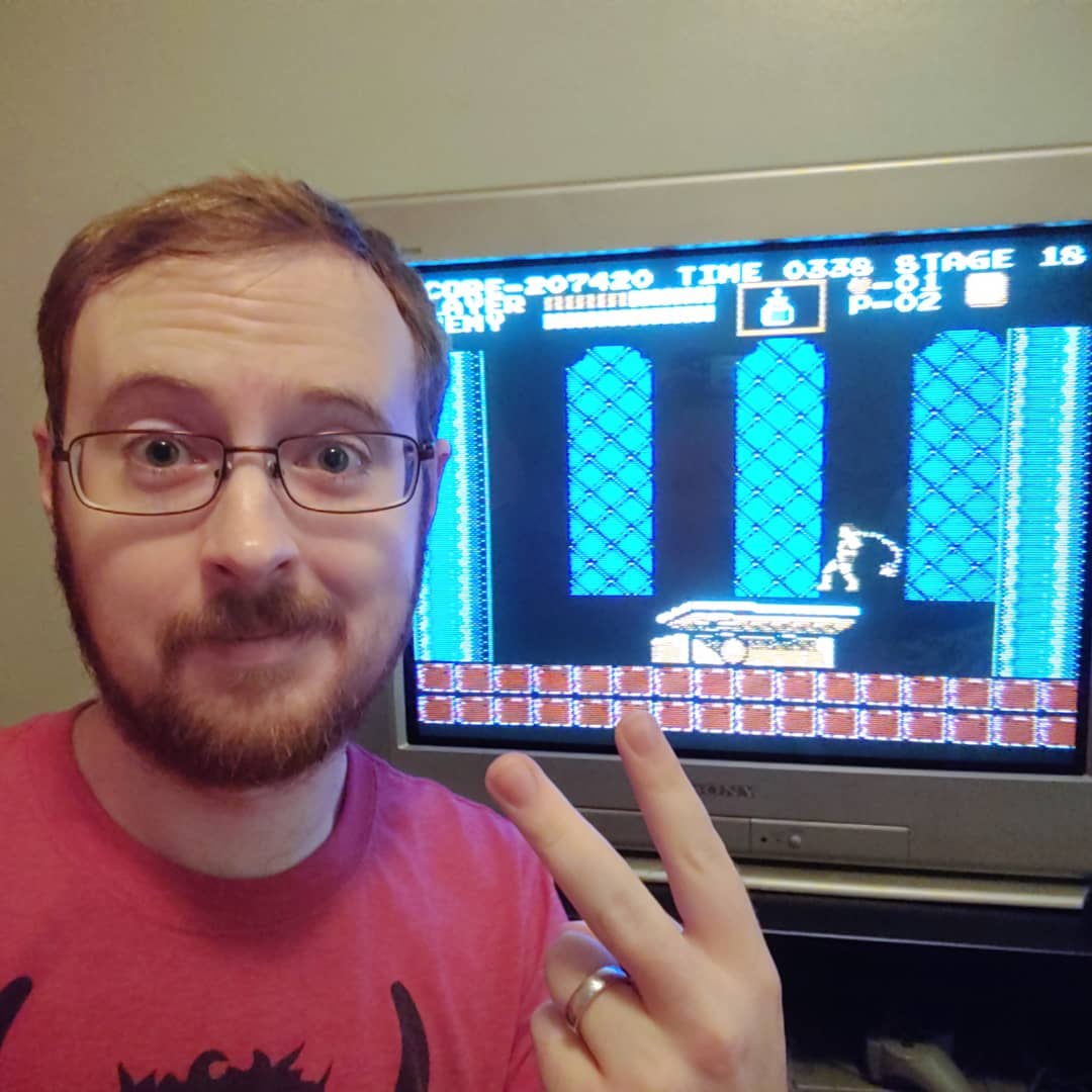 A photo of Tylor in front of a CRT displaying the final boss chamber of Castlevania for the NES