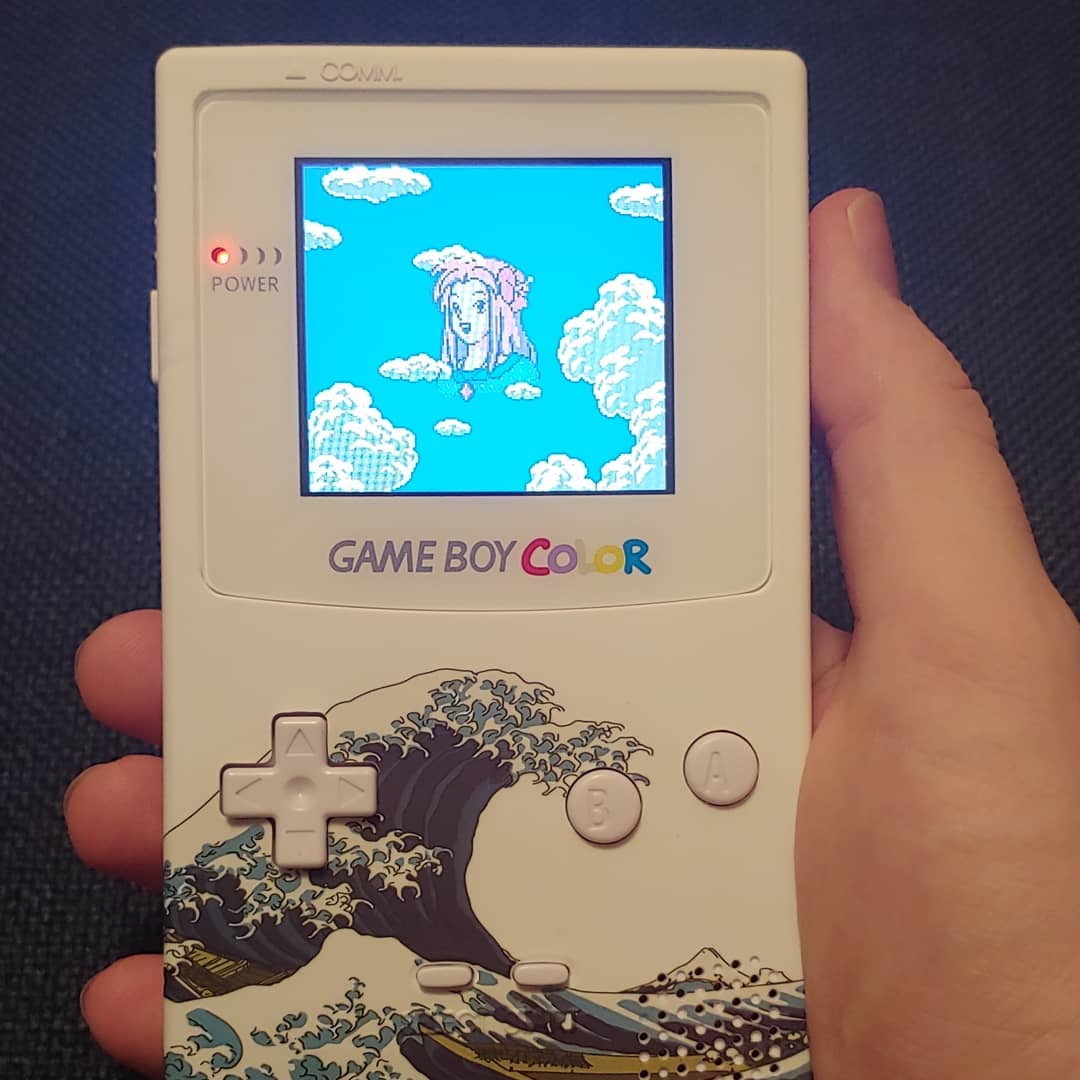 A photo of a modded Game Boy Color displaying the end screen of Link's Awakening Deluxe for the GBC